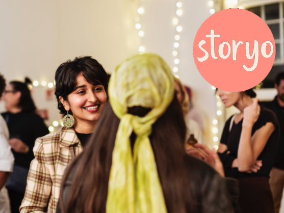 header from StoryO with their log on the top right. It depicts some women smiling at each other at some kind of networking event