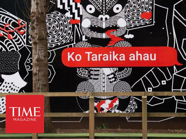 People walk past Maori language signs in Wellington on September 13, 2018