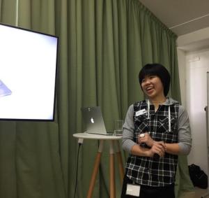 Nitkalya Wiriyanuparb, software engineer, Orion Health quotes Frank Zappa: "A mind is like a parachute. It doesn’t work if it is not open." - Nitkalya standing in a chequered shirt in front of a mac book and a green curtain