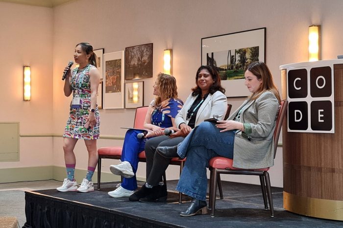 Me, standing on a stage wearing a Star Wars dress speaking into a microphone