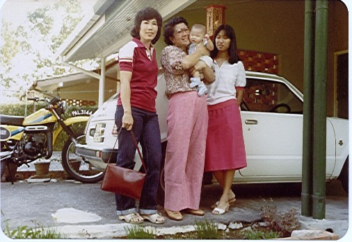 Old photo of me, my mom and my grandma. I'm a baby and there is an old school car behind us