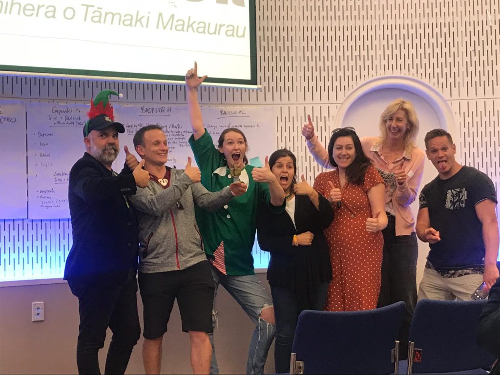 Exuberant photo from the hackathon of me and my colleagues