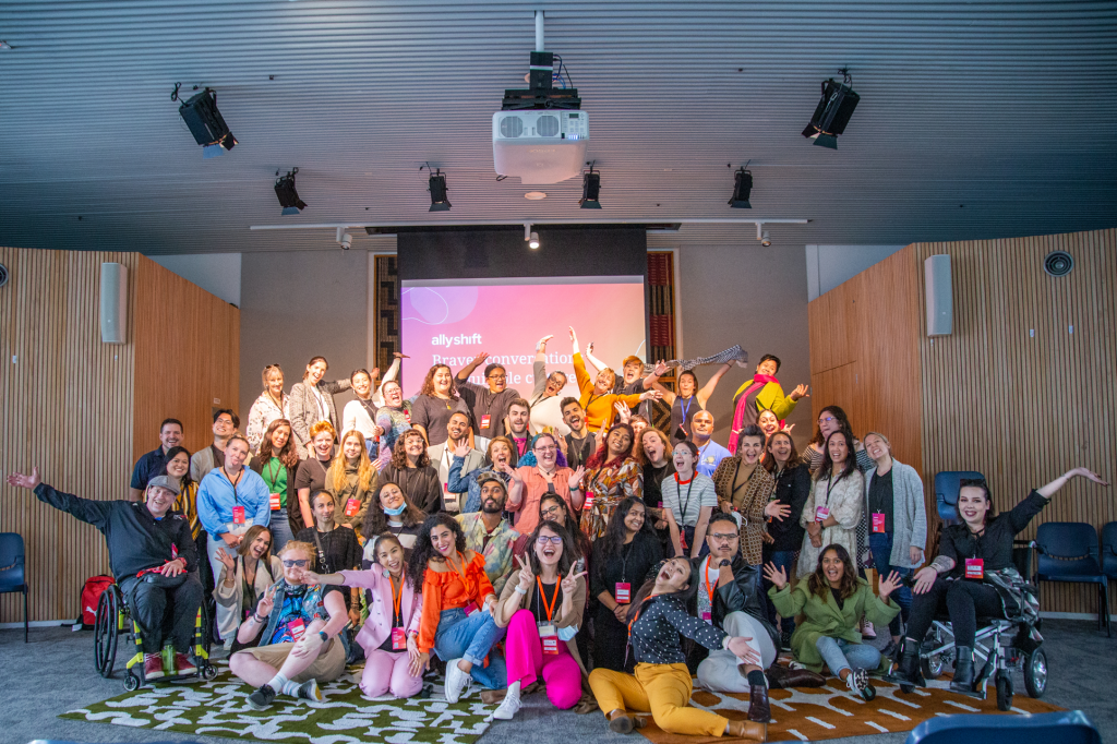 Super colourful photo of all the participants of AllyShift 2024