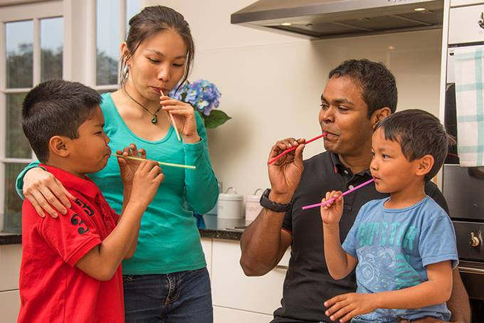 Vivian and her family playing with straws