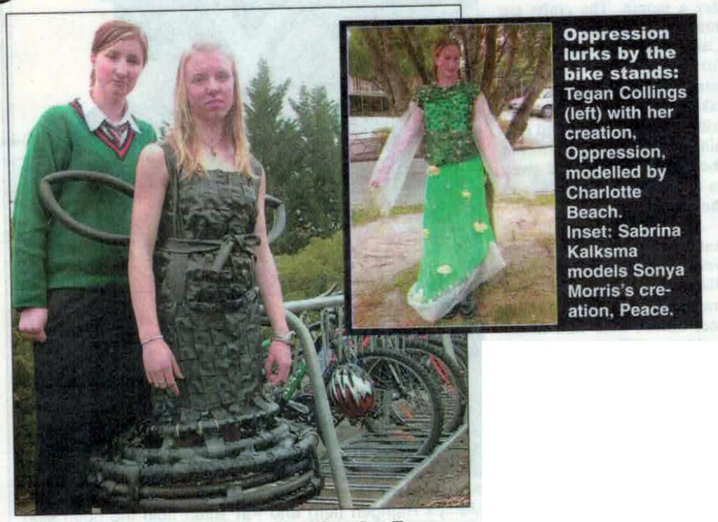 Photo from the Timaru Herald of two of the art works. The caption says "Oppression lurks by the bike stands: Tegan Collings (left) with her creation, Oppression, modelled by Charlotte Beach. Inset: Sabrina Kalksma models Sonya Morris' creation, Peace