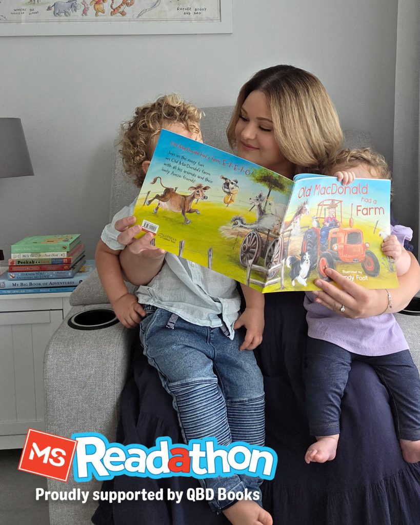 Photo of a woman reading a book with her two kids. The kids are hidden behind the large book. The MS Readathon logo is superimposed over the top of the image.
